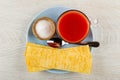 Big potatoes chips, salt in bowl, spoon, cup with tomato juice in plate on wooden table. Top view