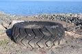 Big Tire on a beach. Pollution and environnement.