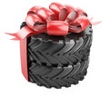 Big tire with red bow and ribbons. Heavy equipment vehicle Royalty Free Stock Photo