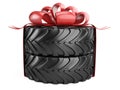 Big tire with red bow and ribons. Heavy equipment vehicle Royalty Free Stock Photo