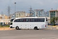 Big tourist buse on parking waiting for passengers on the city street against the backdrop of multi-storey buildings Royalty Free Stock Photo