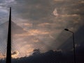 Big tower suspension bridge and lightpost at cloudy sunset