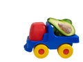 Big toy truck with half of avocado fruit Royalty Free Stock Photo