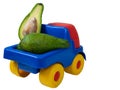 Big toy truck with juicy avocado fruit Royalty Free Stock Photo
