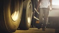 Big Trailer Wheels. Truck Drivers Checking the Truck`s Safety Maintenance Checklist. Inspection Safety of Semi Truck Wheels Tires Royalty Free Stock Photo