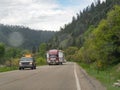 Big truck is loading with a tiny home on the road