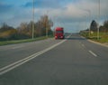 Big truck lorry moving at countryside two lane road