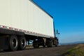 Big truck and trailer on the road with skyline and blue sky back