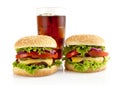 Big two cheeseburgers with glass of cola isolated on white Royalty Free Stock Photo