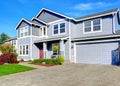 Big two story house. View of entance porch and garage