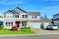 Big two story house. View of entance porch and garage