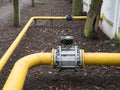Big valve on a thick yellow gas water pipeline tube Royalty Free Stock Photo