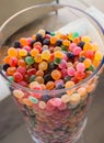 Big vitreous jar full of little round candies in different colors
