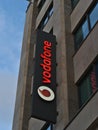 Big Vodafone advertising sign with company logo on building facade above branch in shopping street KÃÂ¶nigstraÃÅ¸e.