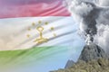 big volcano blast eruption at day time with white smoke on Tajikistan flag background, suffer from eruption and volcanic ash Royalty Free Stock Photo