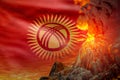 big volcano blast eruption at night with explosion on Kyrgyzstan flag background, problems of eruption and volcanic earthquake