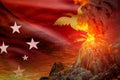 big volcano eruption at night with explosion on Papua New Guinea flag background, problems of natural disaster and volcanic ash Royalty Free Stock Photo