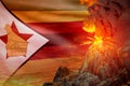 big volcano eruption at night with explosion on Zimbabwe flag background, troubles because of eruption and volcanic earthquake Royalty Free Stock Photo