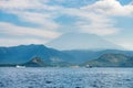 Big volcano rise over the island and sea