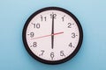 Big wall clock isolated on blue background. Six o`clock. Royalty Free Stock Photo