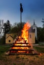 Big walpurgis night fire with witch on pile behind the church