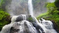 Big Waterfall Cascade with Water Splashing Creating Cataractagenitus Cloud Around Rainforest Royalty Free Stock Photo