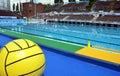 Big waterpolo ball in front of the swimming pool Royalty Free Stock Photo