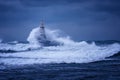 Big wave against old Lighthouse in the port of Ahtopol, Black Sea, Bulgaria on a moody stormy day. Danger, dramatic scene. Royalty Free Stock Photo