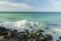 Big wave in Caribbean sea is breaking the coast. Turquoise sea water and blue sky. Eagle Beach of Aruba Island. Royalty Free Stock Photo