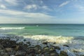 Big wave in Caribbean sea is breaking the coast. Turquoise sea water and blue sky. Eagle Beach of Aruba Island. Royalty Free Stock Photo