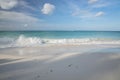 Big wave in Caribbean sea is breaking the coast. Turquoise sea water and blue sky. Eagle Beach of Aruba Island. Royalty Free Stock Photo