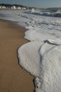 A big wave crashes on the beach