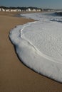 A big wave crashes on the beach