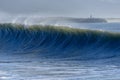 A big wave crashes on the beach