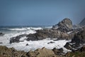 A big wave crashing into the rocks in the rough wild water of the ocean on a stormy during wintertime in South Africa. Royalty Free Stock Photo