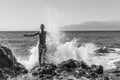 Big wave splash on the man standing on the beach Royalty Free Stock Photo