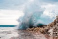 Big wave splash on pier. Big sea wave on a windy day. Waves crash against concrete breakwater at port entrance. Giant waves Royalty Free Stock Photo