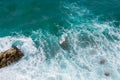 Big waves breaking on the shore. Waves and white foam. Coastal stones. View from above. The marine background is green Royalty Free Stock Photo