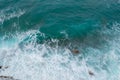 Big waves breaking on the shore. Waves and white foam. Coastal stones. View from above. The marine background is green Royalty Free Stock Photo