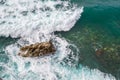 Big waves breaking on the shore. Waves and white foam. Coastal stones. View from above. The marine background is green Royalty Free Stock Photo