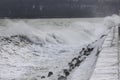 Big waves crashing on breakwater