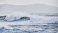 Big waves hit the rocks in rough seas. On a cloudy day. Galicia Spain Royalty Free Stock Photo