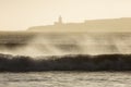 Big waves of ocean in Essaouira with Mosque in background. Morocco Royalty Free Stock Photo