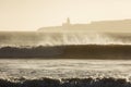 Big waves of ocean in Essaouira with Mosque in background. Morocco Royalty Free Stock Photo