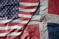 big waving colorful flag of united states of america and national flag of dominican republic Royalty Free Stock Photo