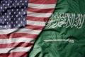 big waving colorful flag of united states of america and national flag of saudi arabia