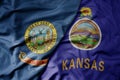 big waving colorful national flag of kansas state and flag of idaho state