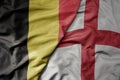 big waving national colorful flag of belgium and national flag of england Royalty Free Stock Photo