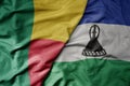 big waving national colorful flag of benin and national flag of lesotho