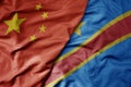 big waving national colorful flag of china and national flag of democratic republic of the congo
